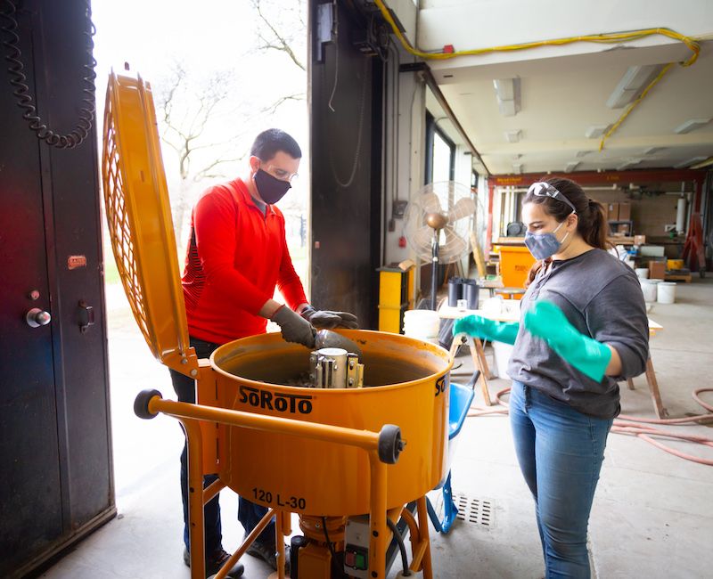 Photo of Assistant Professor Matt Gombeda and student in lab